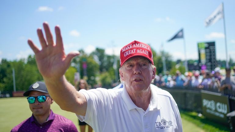 Former President Donald Trump greets supporters and sign autographs during...