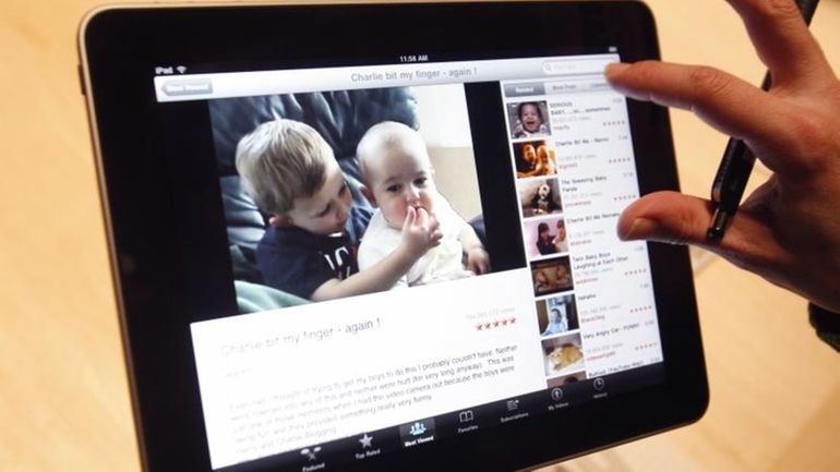 The Apple iPad is examined after its unveiling at the...