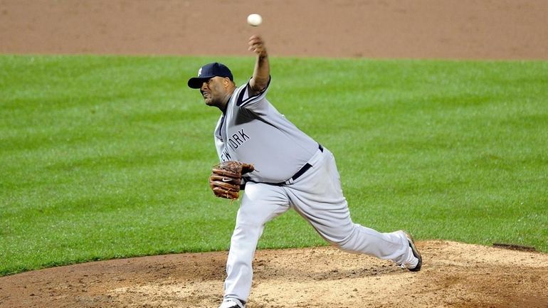 CC Sabathia #52 of the New York Yankees pitches against...