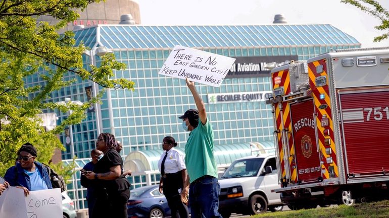 Community members on Saturday demonstrate outside Museum Row to highlight...