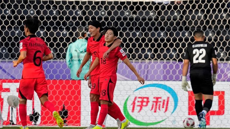 South Korea's Lee Kang-in, third left, celebrates with teammates after...