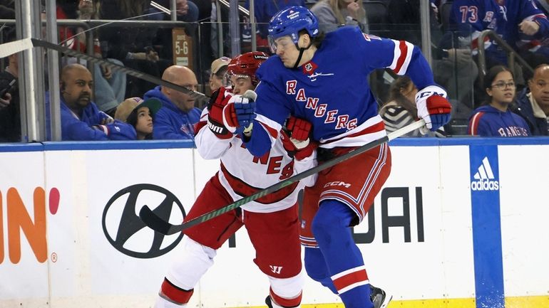 Matt Rempe of the Rangers checks Tony DeAngelo of the...