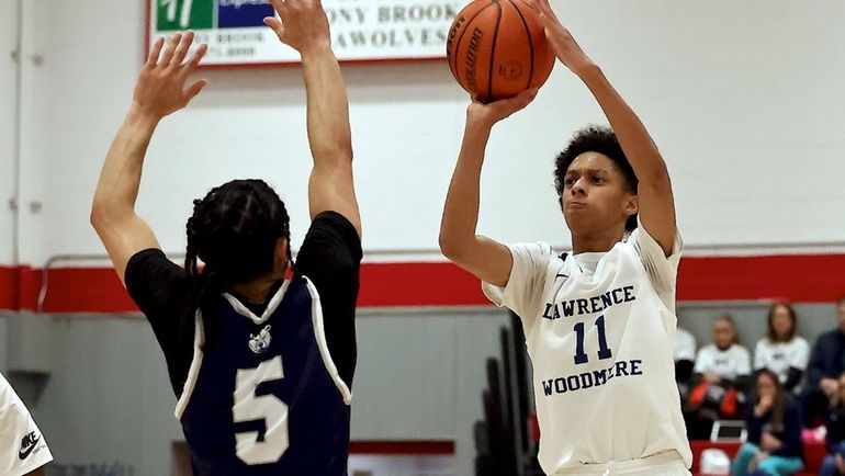 Lawrence Woodmere Academy guard Hank Williams hits the three-point shot...