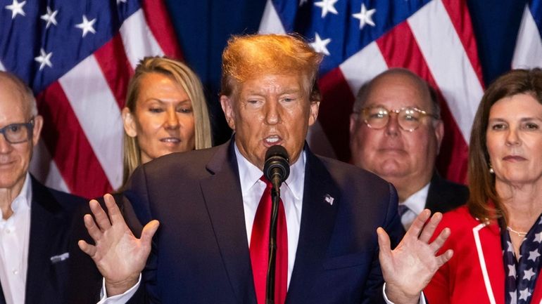 Former US President Donald Trump (C) speaks after defeating former...