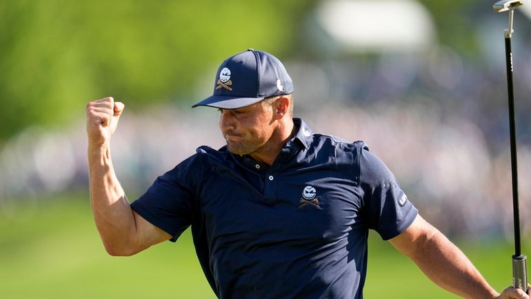 Bryson DeChambeau celebrates after a birdie on the 18th hole...