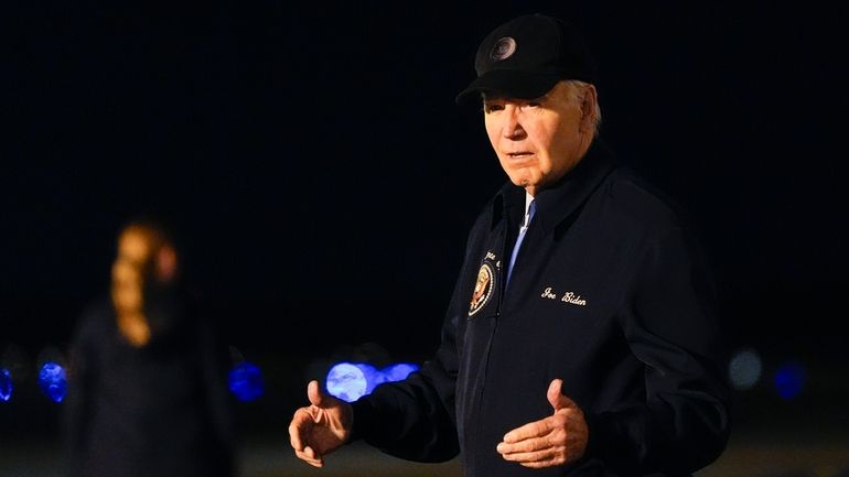 President Joe Biden walks to his car after stepping off...