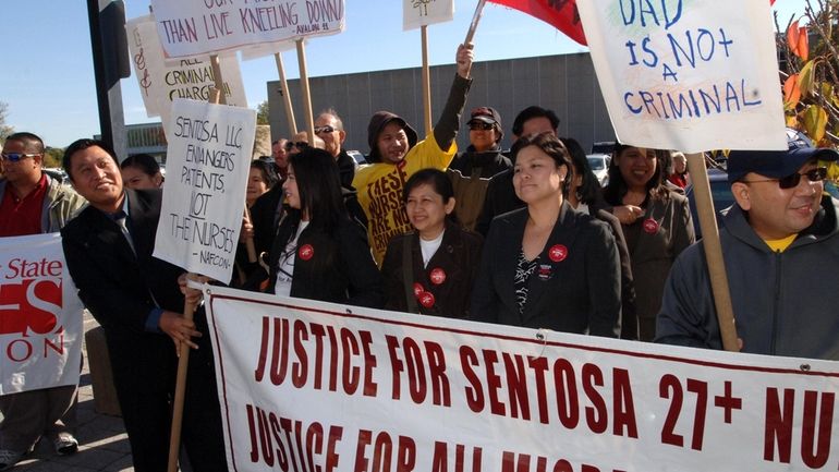 Supporters march outside Suffolk County Court in October 2007 with...