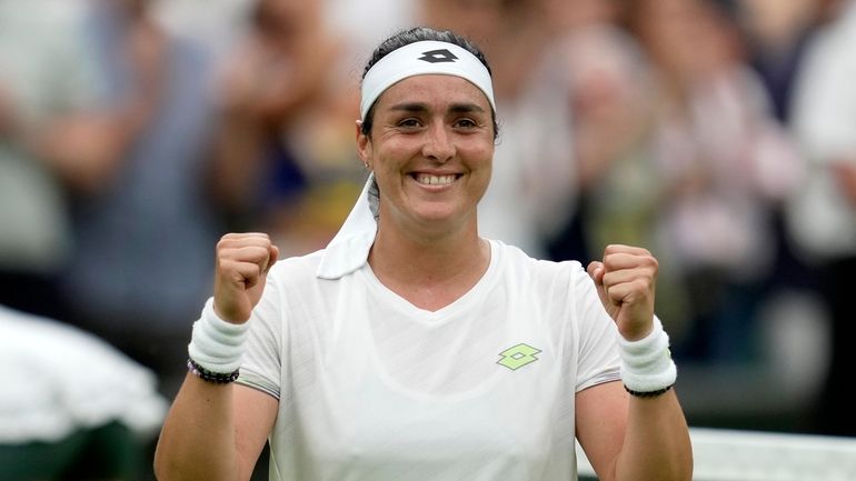 Tunisia's Ons Jabeur celebrates winning against Aryna Sabalenka of Belarus...