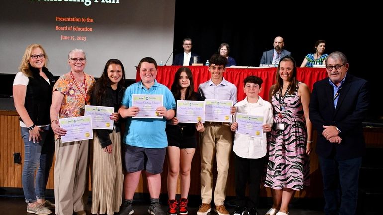 Mineola Middle School students Liam Quinn and Tatiana Marquez (fourth...