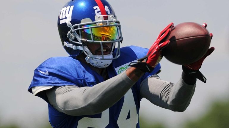 Giants cornerback Terrell Thomas makes a catch during team training...