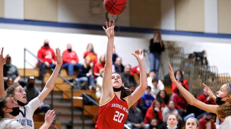 Sacred Heart center Annie Kiernan puts back the rebound for...