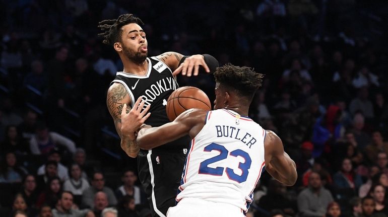 DAngelo Russell of the Brooklyn Nets is fouled by Jimmy...