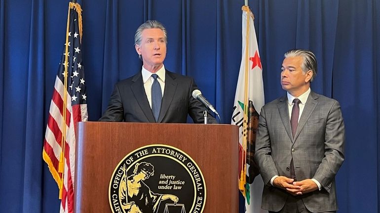 California Gov. Gavin Newsom, left, speaks next to Attorney General...