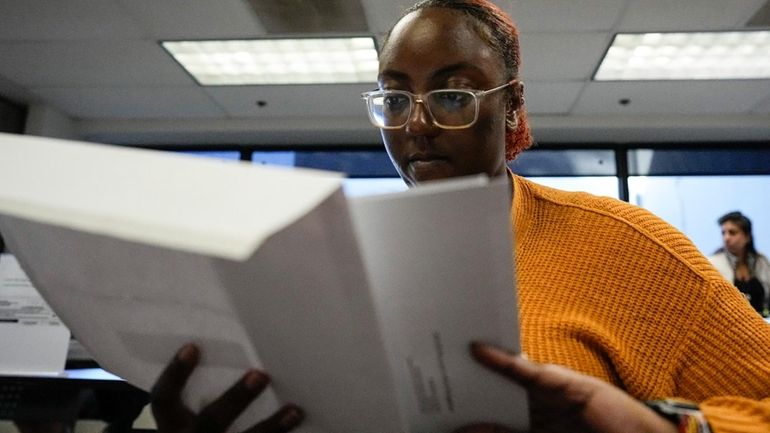 Voter registration specialist Tierra Deans works in the processing center...