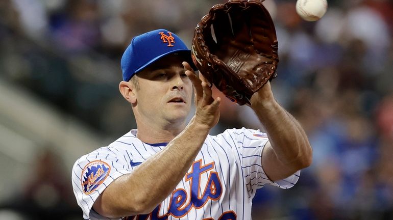 David Robertson of the New York Mets covers first base...