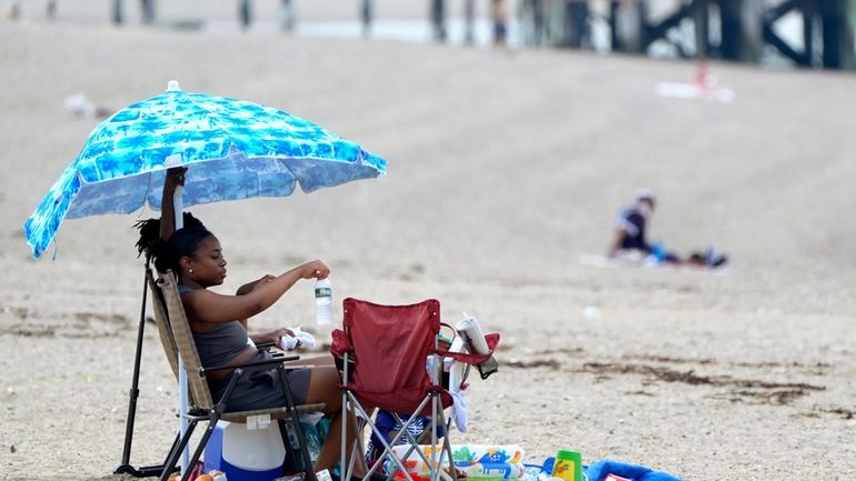 Sierra Payne, of Boston, reaches for a bottle of water...