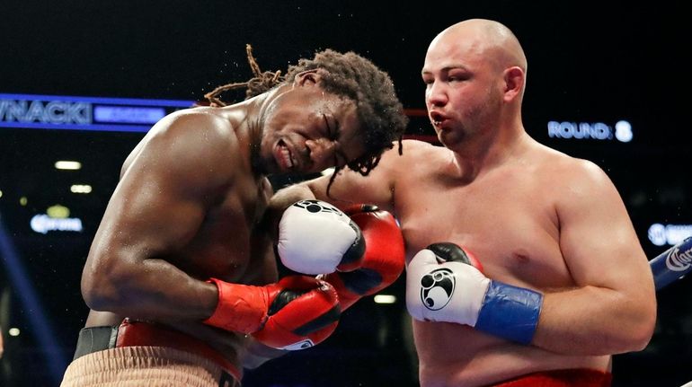 Poland's Adam Kownacki, right, punches Charles Martin during the eighth...