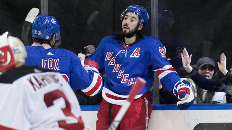 Rangers' Mika Zibanejad, right, celebrates after scoring on New Jersey...