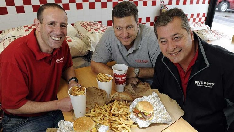 Bill Gellert, left, owns with partners the Five Guys restaurants...