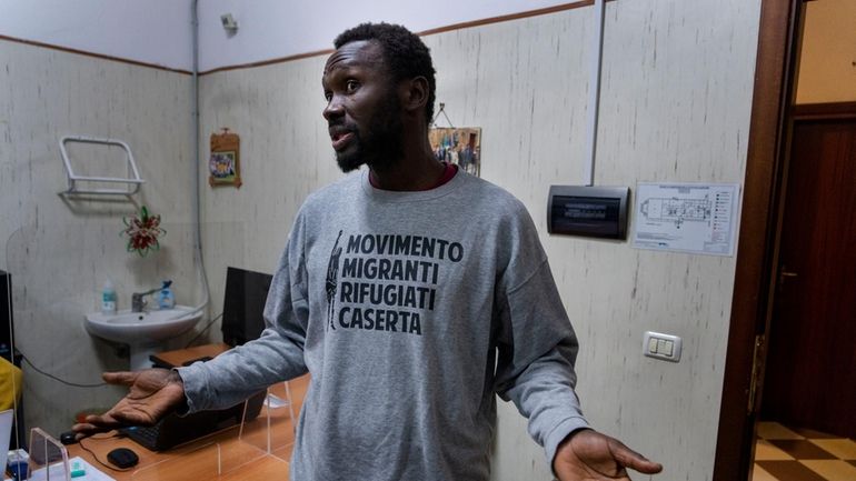 Mamadou Kouassi, left, a migrant who made the journey from...