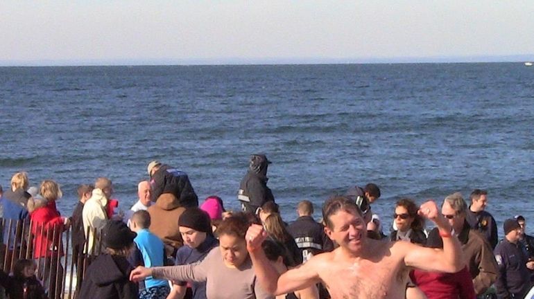 Plungers head out of the water after jumping into the...