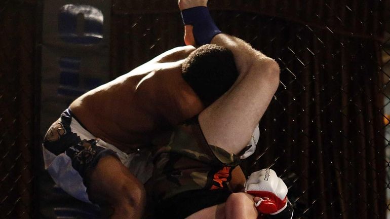 Dakota Giguere (bottom) holds off Victor Robinson in their featherweight...