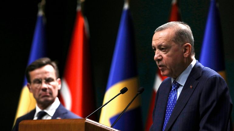 Turkish President Recep Tayyip Erdogan, right, and Sweden's new prime...