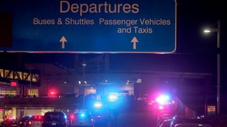 Dozens of police vehicles surround the entrance to