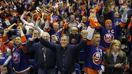 New York Islanders fans celebrate after a third-period