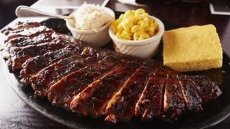 Ribs, are served with mac and cheese, coleslaw