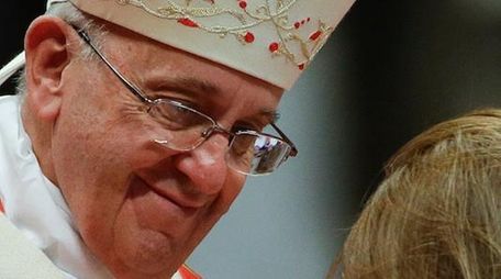 Pope Francis with a baby at a Mass