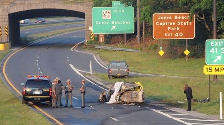 State Police troopers stand at the scene of