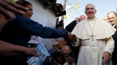 Pope Francis is greeted by the faithful during