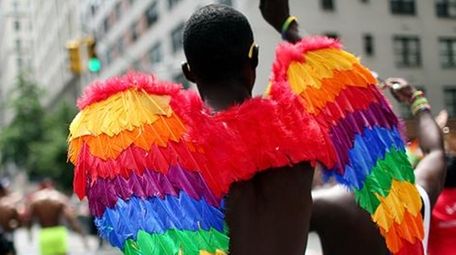 A participant wears multicolored wings while participating in