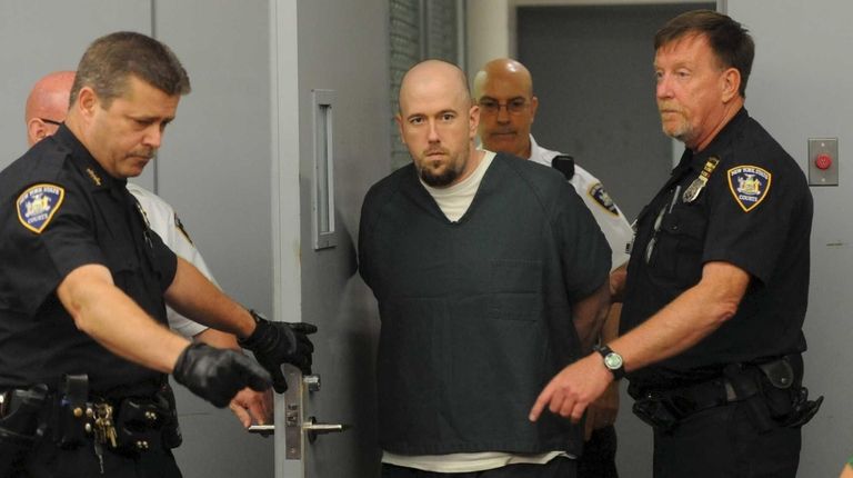 Chad Morizsan, 35, of Northport, is brought into
