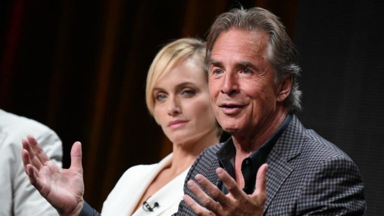 Amber Valletta, left, and Don Johnson speak onstage