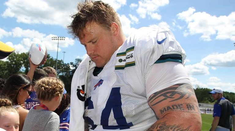 Buffalo Bills guard Richie Incognito signs autographs during