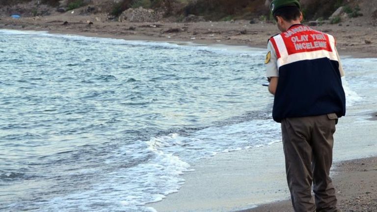 A paramilitary police officer investigates the scene before