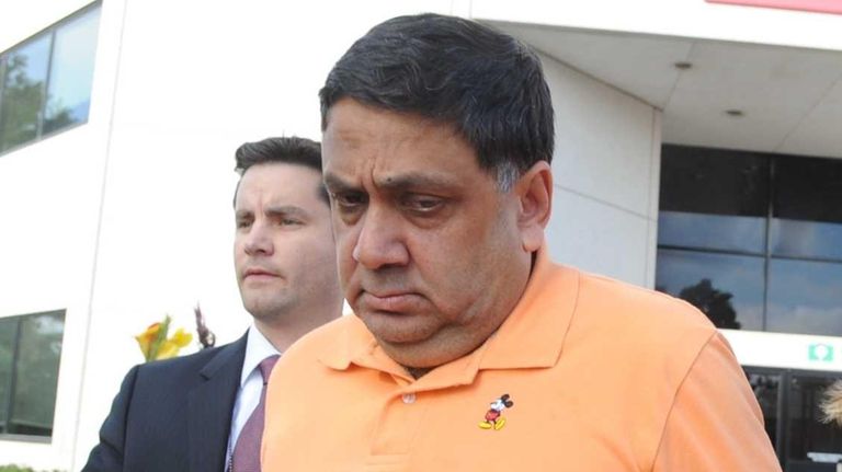 Harendra Singh is led out of the FBI