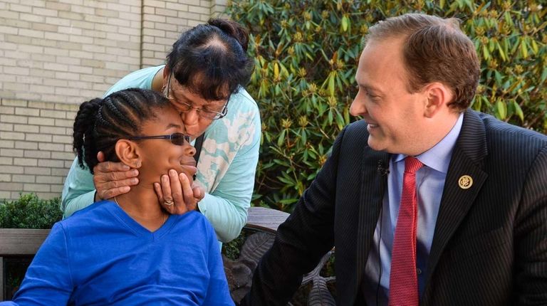 Louisa Lopeztaitt, 10, of Brookhaven, receives a kiss