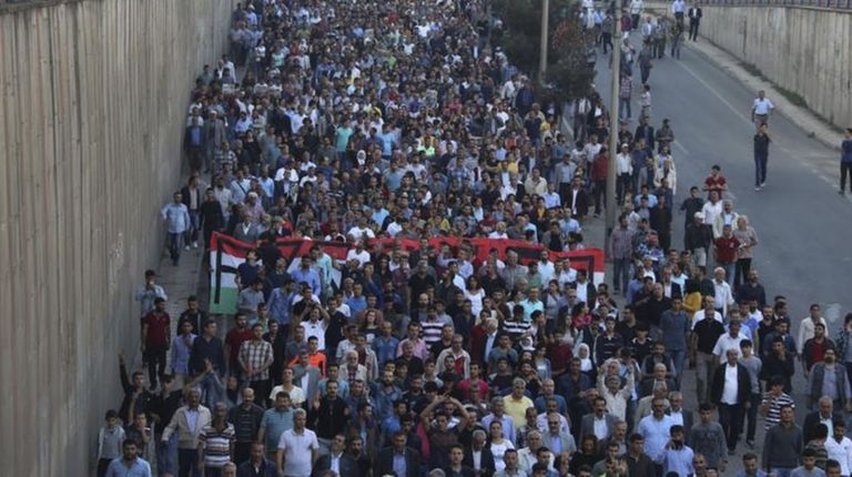 Protesters march to protest Saturday's explosions in Diyarbakir,