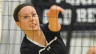 Massapequa's Jamie Smith makes a spike attempt during