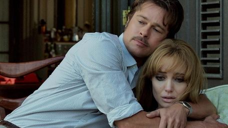 Roland (Brad Pitt) comforts Vanessa (Angelina Jolie Pitt)