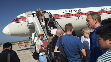 Passengers board an Air Koryo plane at the
