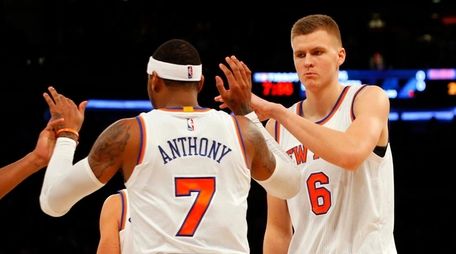 Kristaps Porzingis and Carmelo Anthony celebrate after a