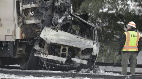 A worker looks over the wreckage after the