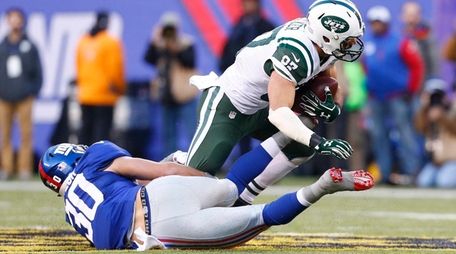 Giants safety Cooper Taylor tries to tackle Jets