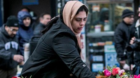 A woman puts a flower on a table