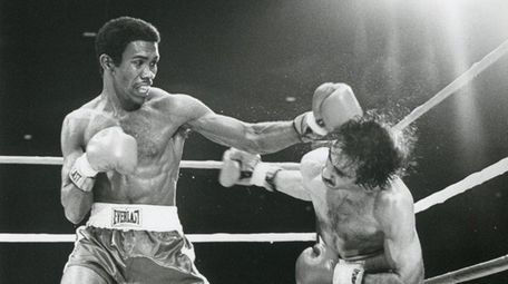 Howard Davis, left, battles Angel Cruz at the