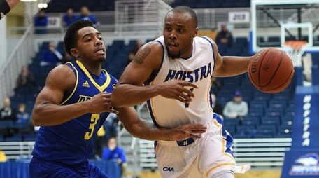 Juan'ya Green (19 points, 11 assists) drives against